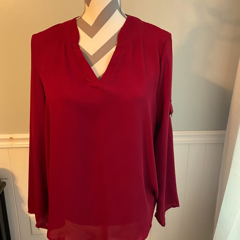 Long sleeve women’s dressy red/maroon top. Can make mid arm length.